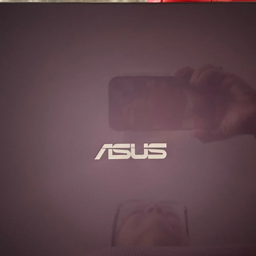 ASUS Laptop monitors Black Textured Laptop Cover with Silver Labels and cables.